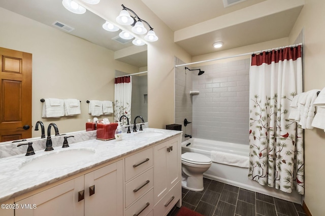 bathroom with toilet, a sink, visible vents, and shower / tub combo with curtain