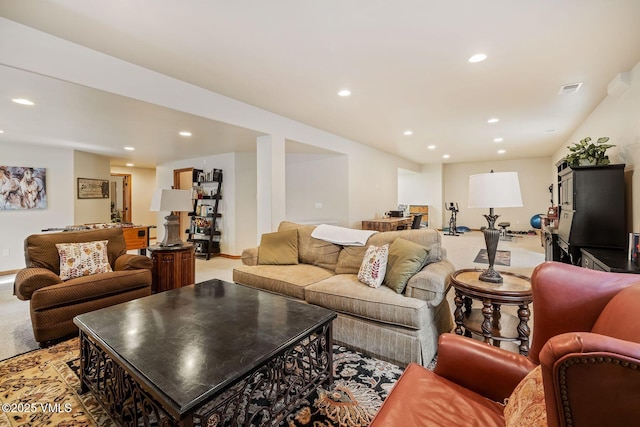 living room featuring recessed lighting, light colored carpet, visible vents, and baseboards