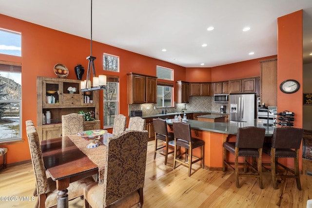 dining space featuring light wood-style floors, plenty of natural light, and recessed lighting