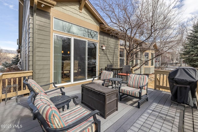 wooden terrace featuring a grill