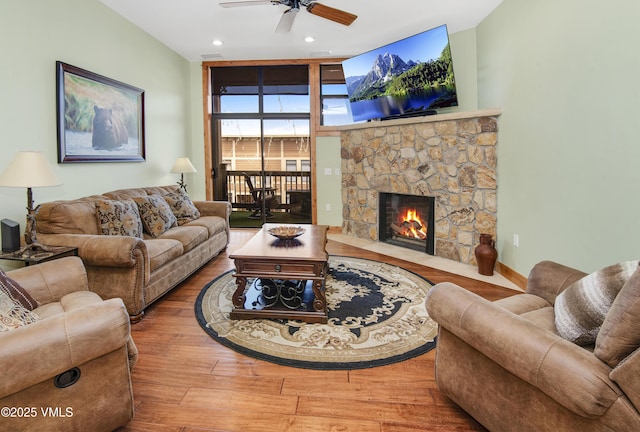 295 Main St Unit R-306, Edwards, CO 81632 - living room with wood finished floors, a ceiling fan, a stone fireplace, and recessed lighting