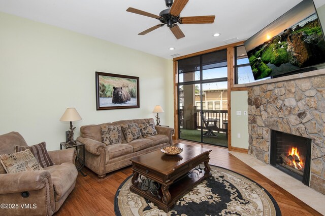 295 Main St Unit R-306, Edwards, CO 81632 - living room featuring wood finished floors, a stone fireplace, ceiling fan, recessed lighting, and a wall of windows