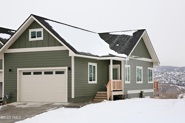 view of front of home with a mountain view and a garage