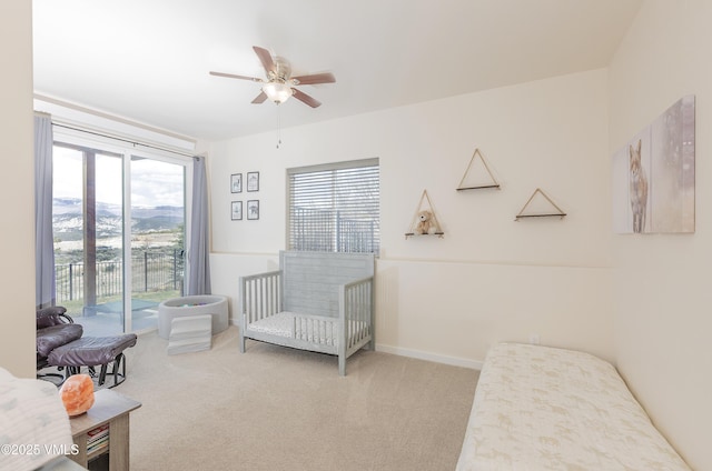 carpeted bedroom with ceiling fan and access to exterior