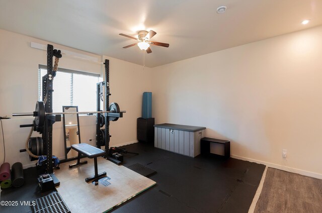 exercise area with ceiling fan and baseboards