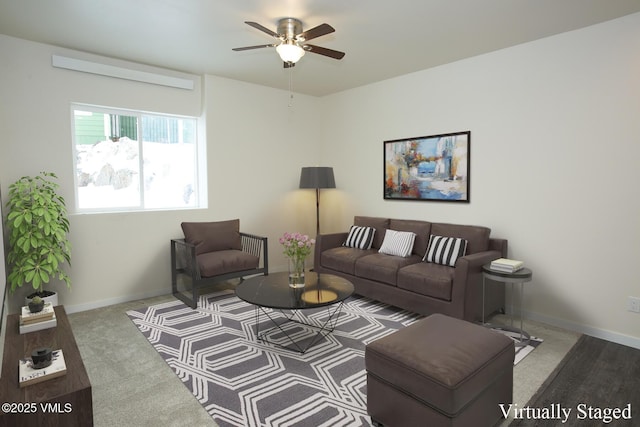 living room featuring ceiling fan and carpet