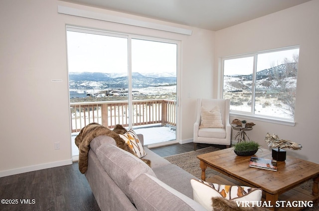 living room with dark hardwood / wood-style floors and a mountain view