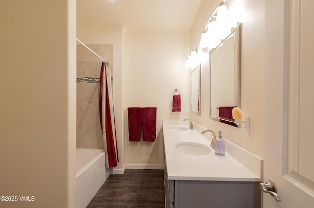 full bathroom featuring shower / tub combo, double vanity, a sink, and wood finished floors