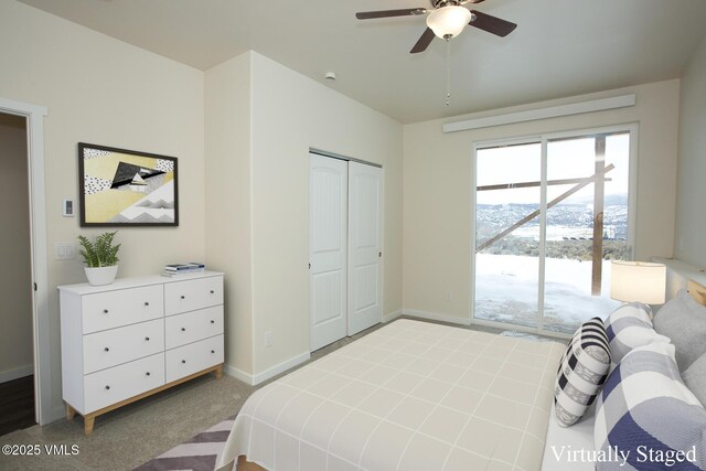 bedroom with ceiling fan, carpet flooring, a mountain view, access to outside, and a closet