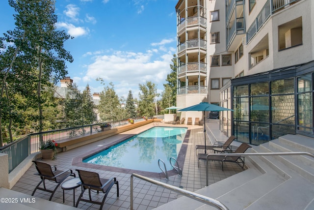 view of swimming pool with a patio area