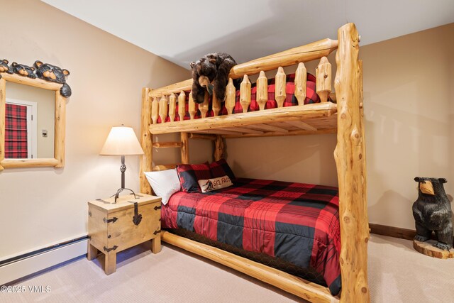 bedroom featuring baseboard heating and carpet floors