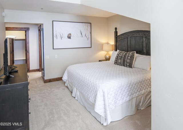 bedroom featuring light colored carpet