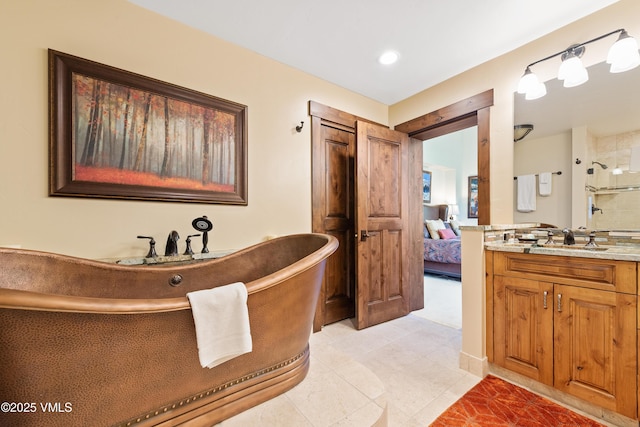 bathroom with vanity and shower with separate bathtub