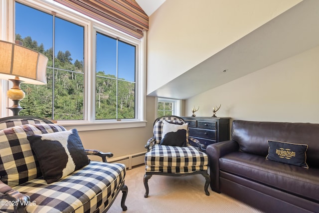 sitting room with vaulted ceiling, a baseboard radiator, and carpet