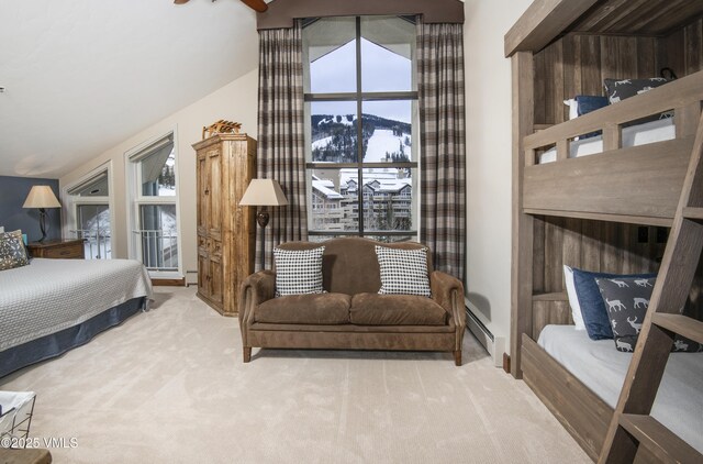 bedroom featuring light colored carpet, a baseboard radiator, a mountain view, and vaulted ceiling