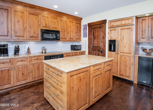 kitchen featuring light stone counters, black appliances, dark hardwood / wood-style flooring, a kitchen island, and backsplash