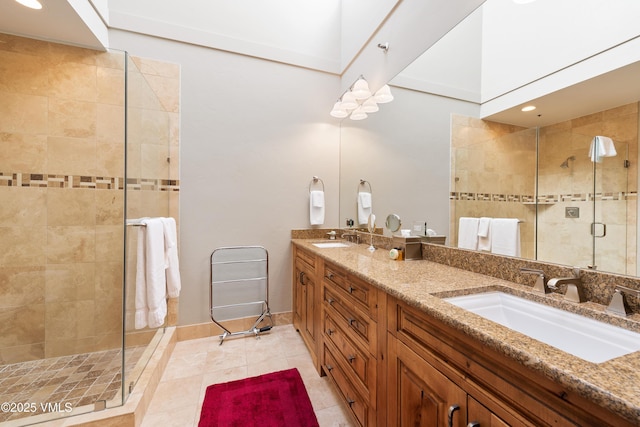 bathroom with tile patterned floors, vanity, and a shower with shower door