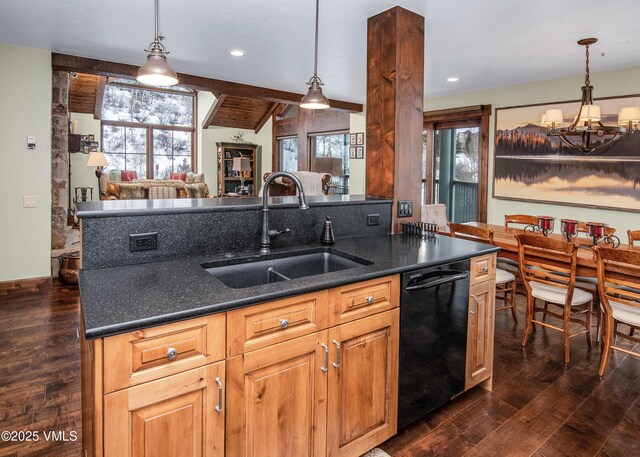 kitchen featuring black dishwasher, sink, and hanging light fixtures