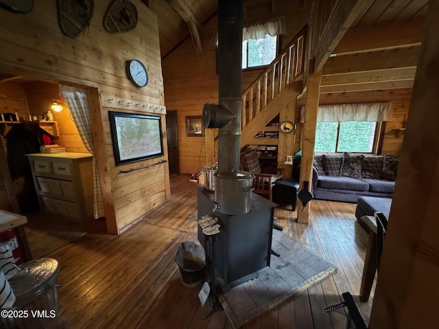 1234 6th St, Eagle, CO 81631 - living room with wood walls, healthy amount of natural light, hardwood / wood-style flooring, stairway, and a wood stove