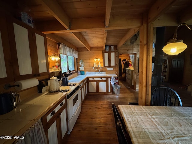 1234 6th St, Eagle, CO 81631 - kitchen featuring tile counters, white gas range, dark wood finished floors, wood walls, and a wood ceiling with exposed beams