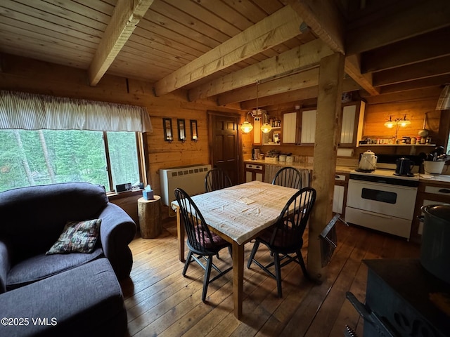 1234 6th St, Eagle, CO 81631 - dining room with wooden walls, dark wood finished floors, heating unit, a wood ceiling with exposed beams, and a chandelier