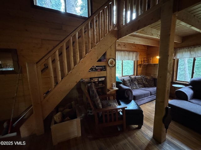 1234 6th St, Eagle, CO 81631 - living room featuring wood walls, hardwood / wood-style floors, and a high ceiling