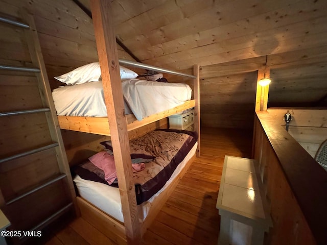 1234 6th St, Eagle, CO 81631 - bedroom featuring wood walls, wood-type flooring, vaulted ceiling, and a sauna / steam room