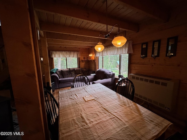 1234 6th St, Eagle, CO 81631 - dining area featuring radiator heating unit, wooden walls, a wooden ceiling with exposed beams, and wood finished floors