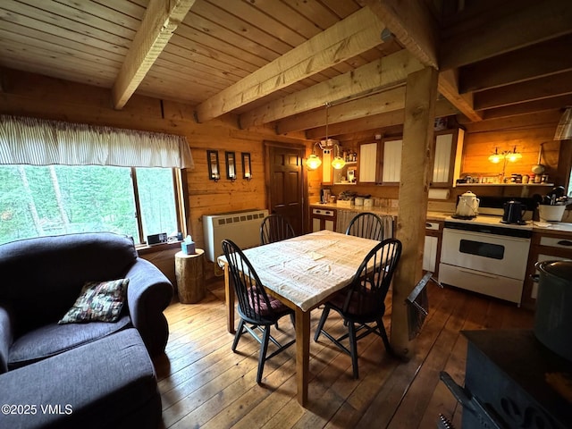 1234 6th St, Eagle, CO 81631 - dining room featuring wooden walls, dark wood-style flooring, heating unit, and a wood ceiling with exposed beams
