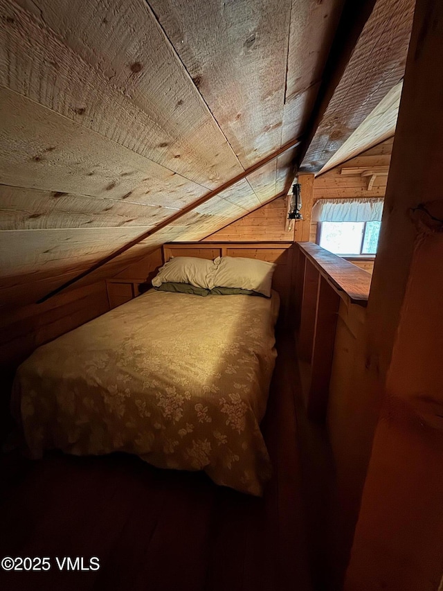 1234 6th St, Eagle, CO 81631 - bedroom featuring vaulted ceiling, wooden walls, and wood finished floors