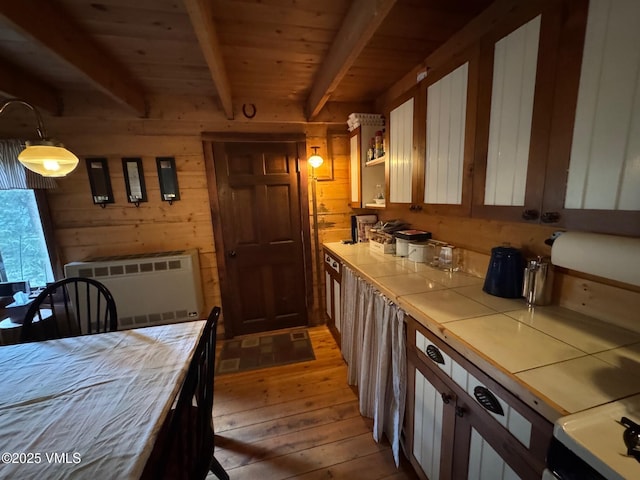 1234 6th St, Eagle, CO 81631 - kitchen featuring tile countertops, light wood finished floors, a wooden ceiling with exposed beams, radiator, and open shelves