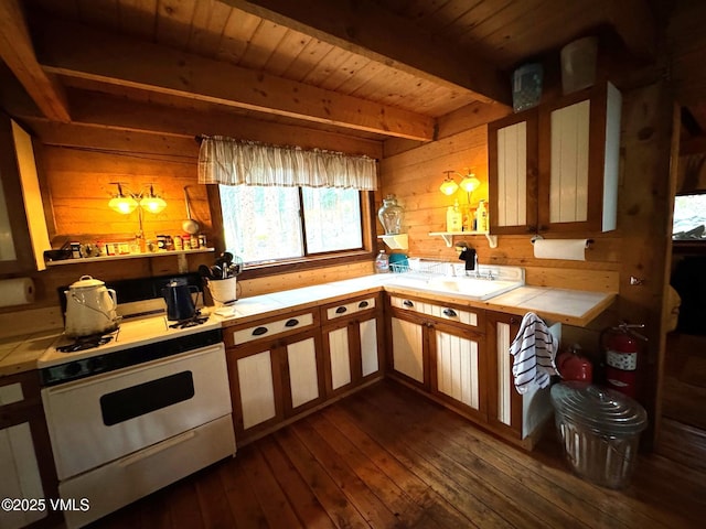 1234 6th St, Eagle, CO 81631 - kitchen with white range oven, tile counters, wooden walls, dark wood-type flooring, and a wood ceiling with exposed beams