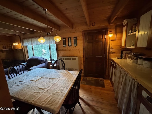 1234 6th St, Eagle, CO 81631 - dining space featuring hardwood / wood-style floors, wood walls, radiator, and a wooden ceiling with exposed beams