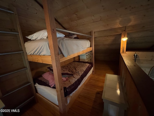 1234 6th St, Eagle, CO 81631 - bedroom featuring hardwood / wood-style floors, wooden walls, and vaulted ceiling