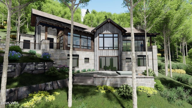 rear view of house featuring stone siding, a patio area, and a balcony