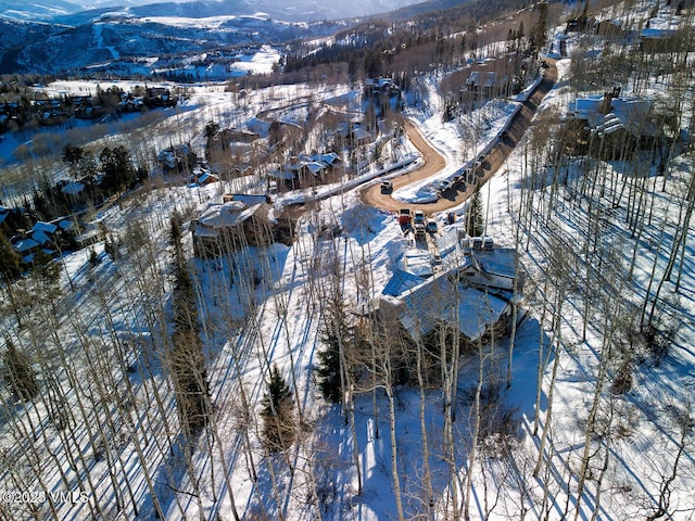 snowy aerial view featuring a mountain view