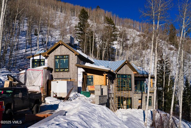 rustic home featuring stone siding