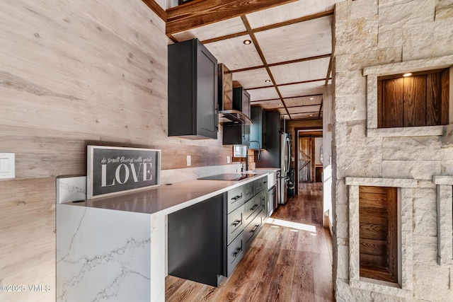 329 River Frontage Rd Unit 18, Silt, CO 81652 - kitchen featuring wooden ceiling, wall chimney exhaust hood, wood finished floors, a high ceiling, and black electric stovetop
