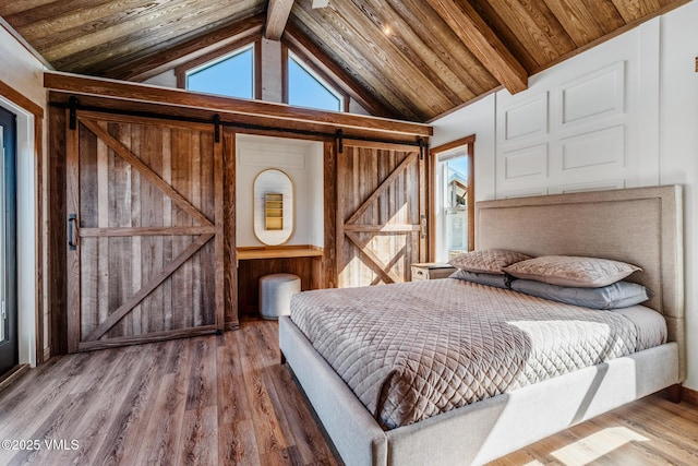 329 River Frontage Rd Unit 18, Silt, CO 81652 - bedroom featuring vaulted ceiling with beams, a barn door, wood finished floors, and wood ceiling