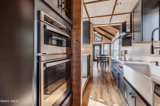 329 River Frontage Rd Unit 18, Silt, CO 81652 - kitchen featuring tasteful backsplash, wood ceiling, light wood-style flooring, light countertops, and double oven