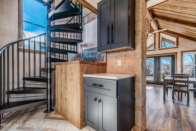 329 River Frontage Rd Unit 18, Silt, CO 81652 - interior space with french doors, beam ceiling, gray cabinets, light countertops, and light wood-style flooring