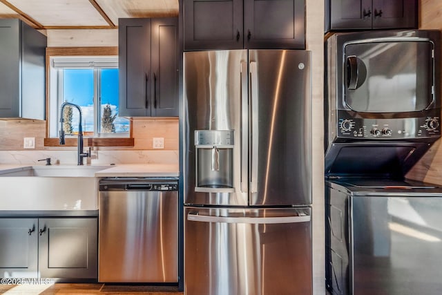 329 River Frontage Rd Unit 18, Silt, CO 81652 - kitchen with appliances with stainless steel finishes, a sink, decorative backsplash, and stacked washing maching and dryer