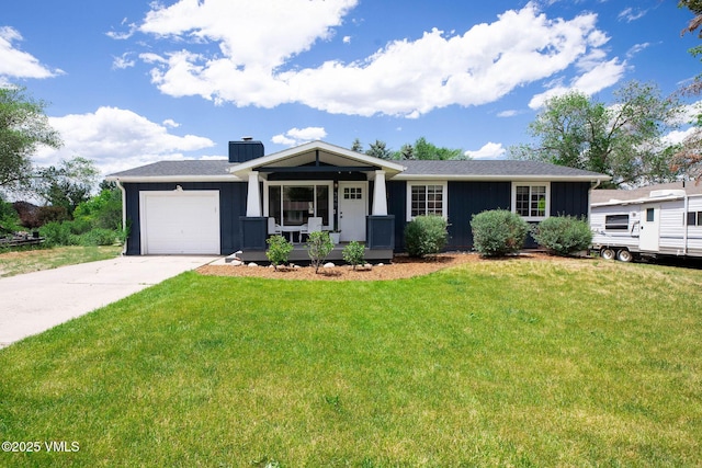 349 Whiting Rd, Eagle, CO 81631 - view of front of property featuring an attached garage, covered porch, a front lawn, a chimney, and concrete driveway