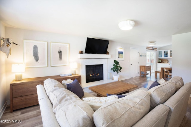 349 Whiting Rd, Eagle, CO 81631 - living area featuring wood finished floors and a warm lit fireplace