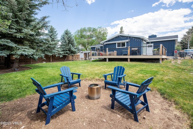 349 Whiting Rd, Eagle, CO 81631 - rear view of house with a deck, board and batten siding, a yard, and an outdoor fire pit
