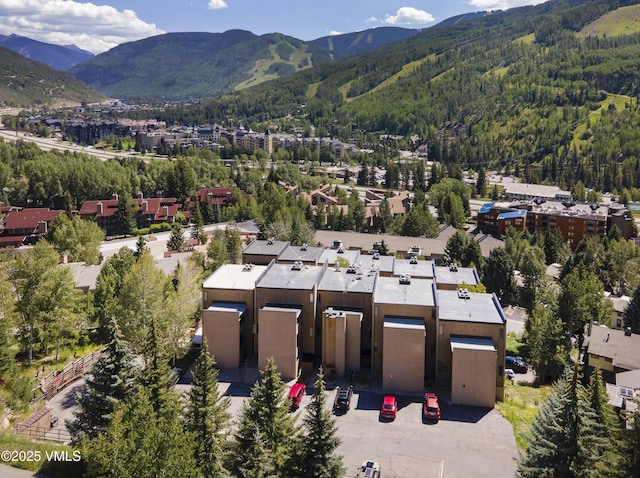 birds eye view of property with a mountain view and a wooded view