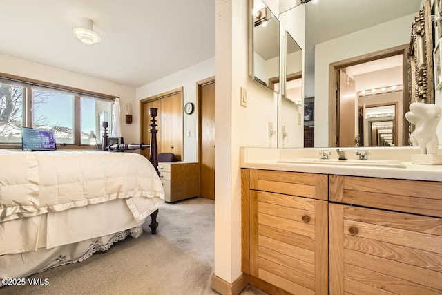 bedroom with a sink and light carpet