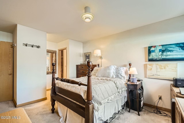 bedroom with baseboards and light carpet