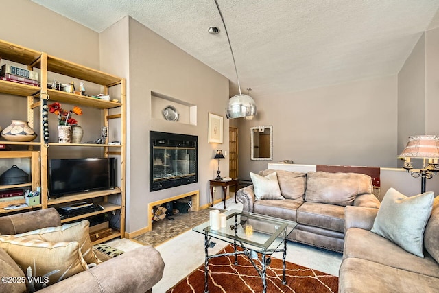 living area featuring a fireplace, a textured ceiling, and baseboards