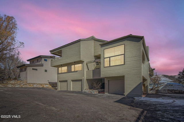 view of front of house featuring aphalt driveway and an attached garage